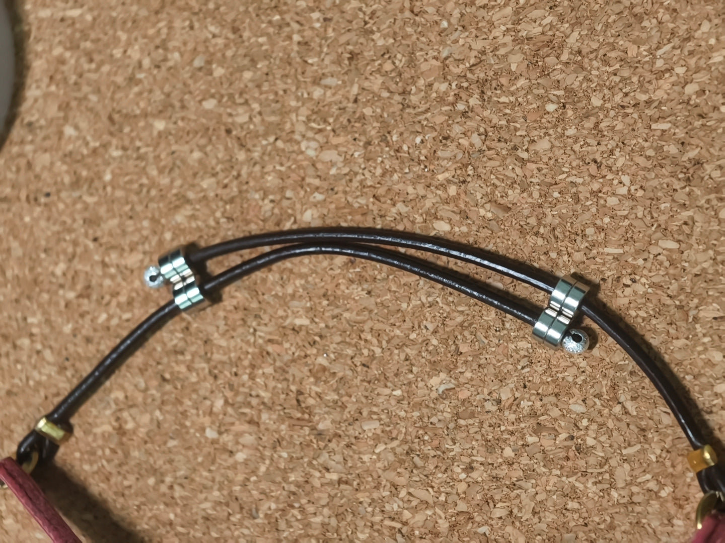 The small metal breakaway clasp on the leather cord